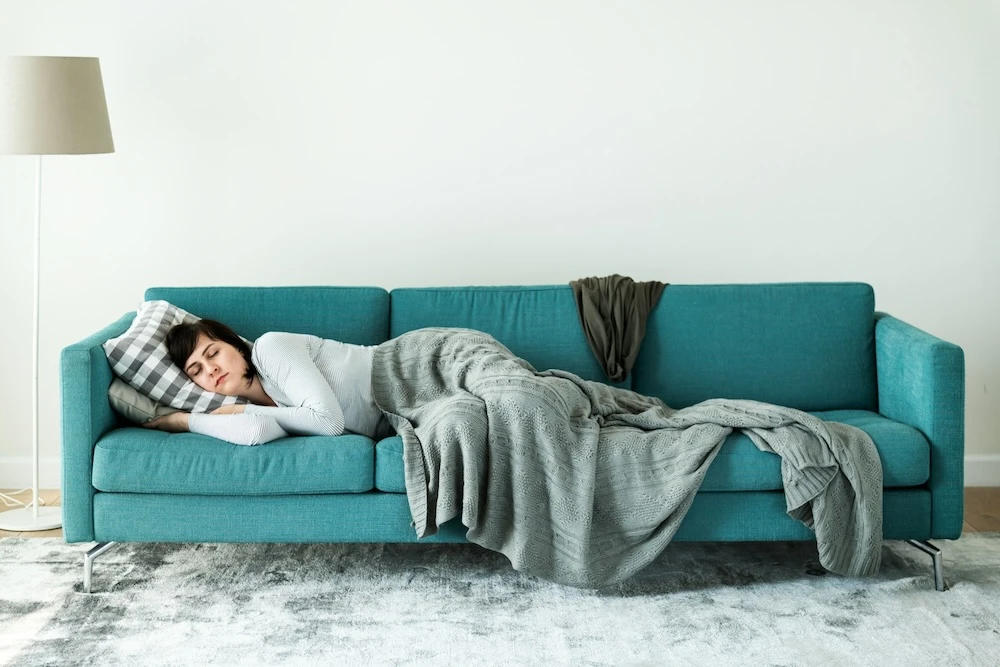 woman sleeping on the sofa dreaming about snakes