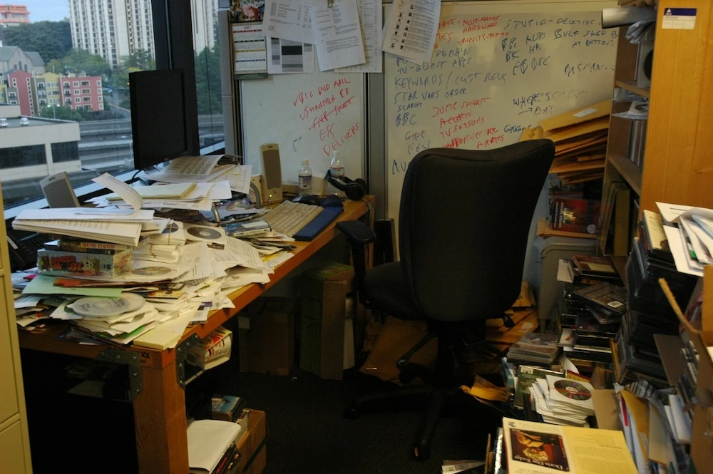extremely untidy desk and area around it